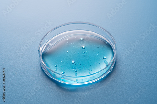 Cosmetic formulation in petri dish with blue liquid