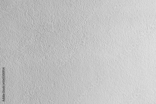 A close-up view of a rough white plaster wall texture, showing its subtle patterns and natural imperfections, perfect for background or design inspiration.