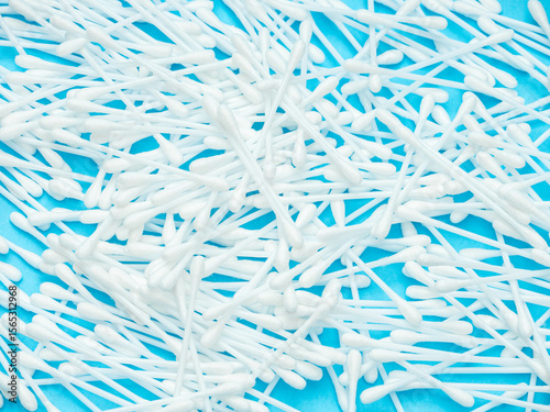 White Cotton Swabs Scattered on Blue Background