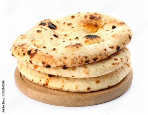 Stack of fluffy naan breads on wooden cutting board, isolated 