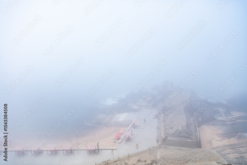 Obraz premium Foggy Summer Morning at Santa Cruz Beach, Torres Vedras, Portugal. July 4, 2025
