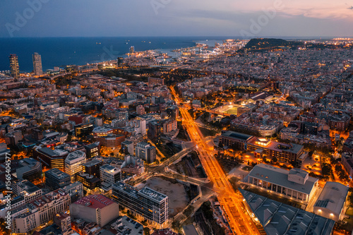 
Barcelona Urban Grid: Illuminated Streets and Residential Blocks at Dusk

An aerial view of Barcelona's Eixample district at dusk, showcasing its iconic grid pattern of illuminated 