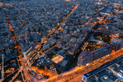 
Barcelona Urban Grid: Illuminated Streets and Residential Blocks at Dusk

An aerial view of Barcelona's Eixample district at dusk, showcasing its iconic grid pattern of illuminated streets and dense 