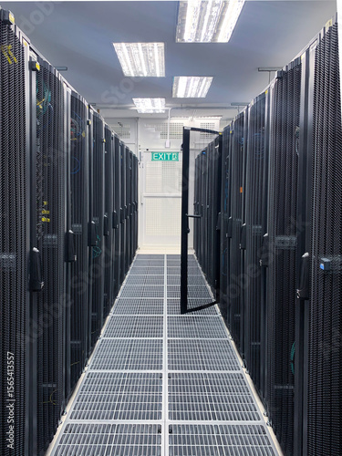 Modern IT server room with rows of black server racks in a high-tech data center environment, showcasing advanced technology, cyber security, and digital infrastructure.