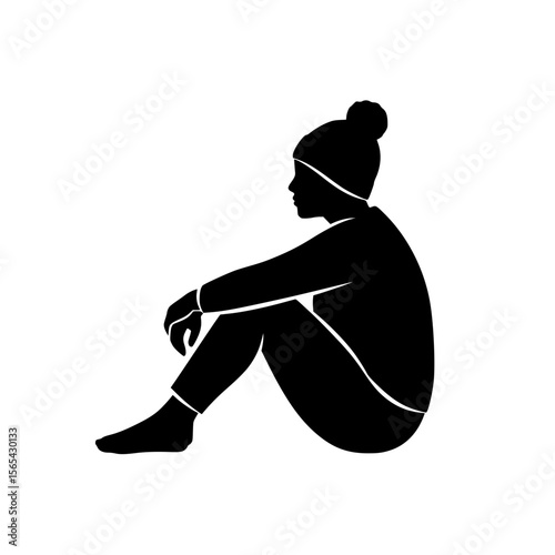 Silhouette of a Person Sitting on the Ground Wearing Winter Clothing