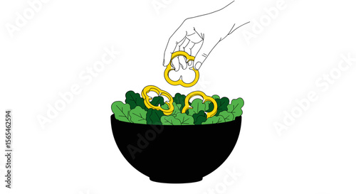 Hand adding yellow bell pepper rings to a bowl of fresh leafy greens on white background, healthy salad preparation concept