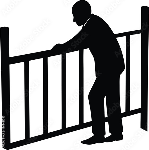 Silhouette of a man leaning on a fence looking down in contemplation