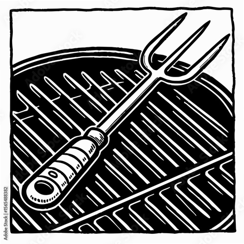 Black and white barbecue fork on grill cooking food