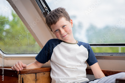 Boy smiling while enjoying the view from a boat in Venice