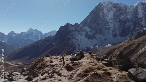Hiker's Journey Through the Majestic Himalayas of Nepal, Capturing the Serenity of Snow-Capped Peaks and Prayer Flags