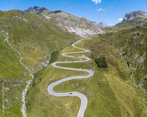 Aerial panorama view of the winding road over the  Julier Pass in Swiss Alps mountain in summer, Canton Grison, Switzerland
