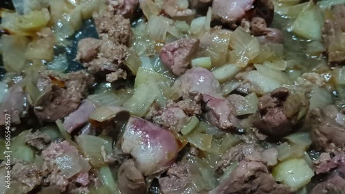 Fried chicken liver with onions in a skillet 