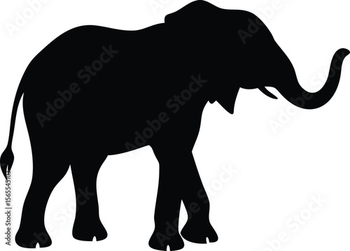 A majestic african elephant walking with its trunk raised in a silhouette