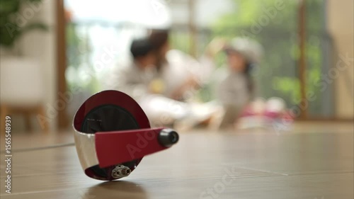 A girl and boy in fencing gear with their mother preparing food and sports equipment before practicing fencing in preparation for the upcoming competition day