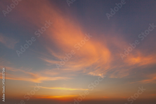 Canvas Print Beautiful sunset painting the sky with hues of orange and pink over a serene hor