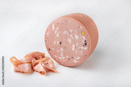Traditional Italian artisan handcrafted fine mortadella with pistachio and truffle offered as close-up on white background with copy space – isolated