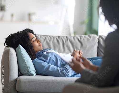 Firefly young woman reflecting during therapy session in cozy psychologist’s office with calming atmosphere