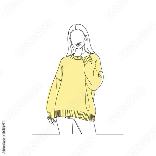 Young woman in yellow sweater posing on minimalistic background  