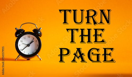 Turn the Page symbol. Concept words Turn the Page on Beautiful orange background with alarm clock. Business and Turn the Page concept. Copy space.