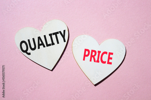 Price or Quality symbol. Concept word Price or Quality on wooden hearts. Beautiful pink background. Business and Price or Quality concept. Copy space
