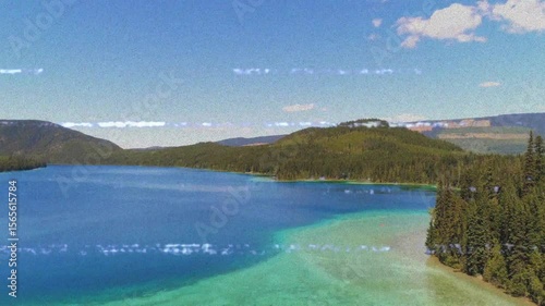 Opening aerial shot revealing turquoise shallows, forest lakeside homes and hills framing blue lake