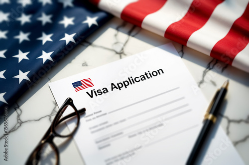 US Visa Application form on a marble desk, with an American flag. A symbol of immigration, legal process, global mobility, and new opportunities.