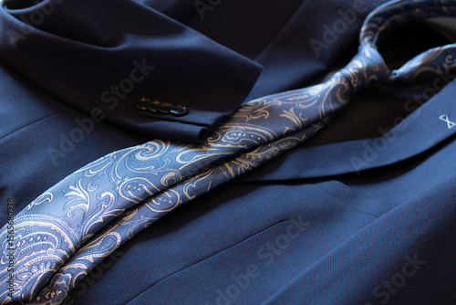 Close-up of a modern Italian necktie on an elegant blue suit. Concept: wedding day, fashion for businessmen.