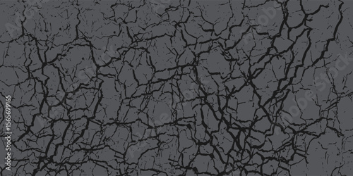 A close-up of cracked earth texture displaying deep crevices and intricate natural patterns, ideal for backgrounds or design inspiration. The patterns evoke rugged