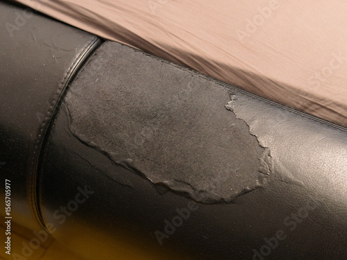 Torn leather sofa trim. Large hole