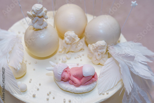 Beautifully crafted cake centerpiece featuring a sleeping baby and decorative elements for a special celebration