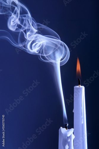 Smoke from an extinguished candle on a dark background. The concept of spirituality and the end of life.