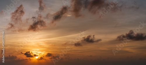 Beautiful sunset sky scenery. Bright colorful orange and yellow clouds on horizon