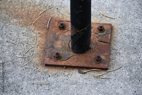 Rusted bracket on support pole. 