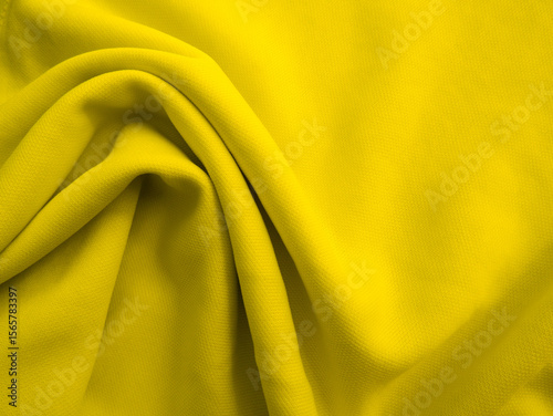 Yellow wavy fabric background. Wrinkled cloth