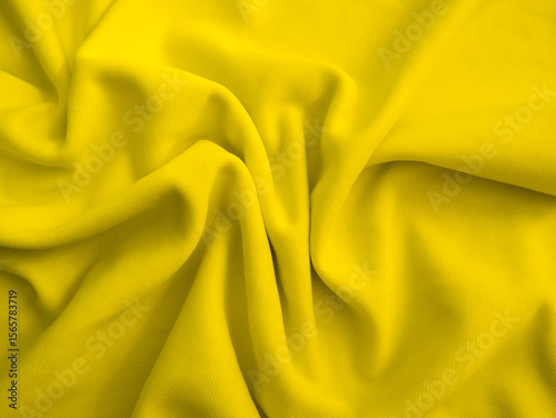 Yellow wavy fabric background. Wrinkled cloth