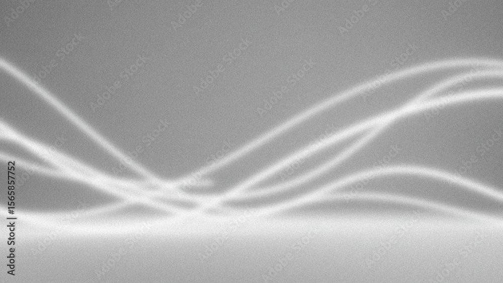 Obraz premium Soft light patterns cast on a textured gray surface creating abstract shadows and highlights