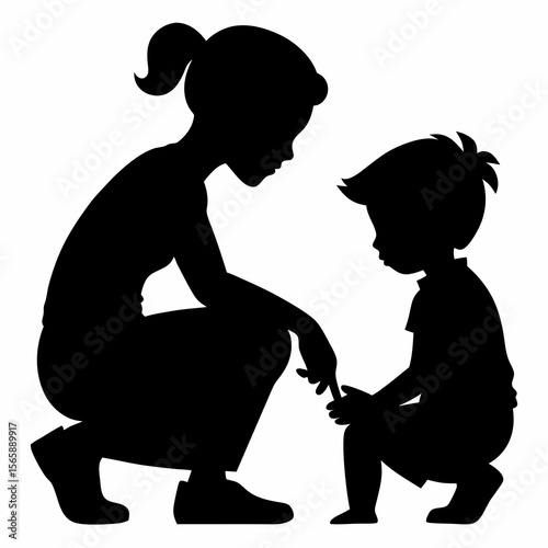 Mother squatting down talking to her son silhouette