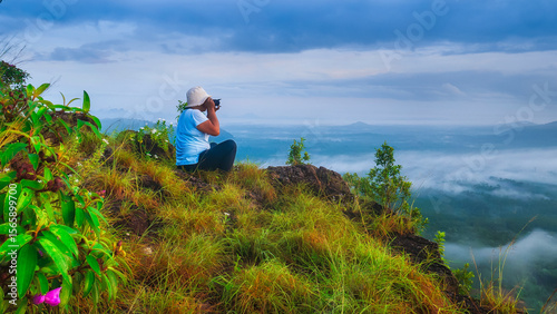 A tourist capturing the beauty of nature in the early morning light.