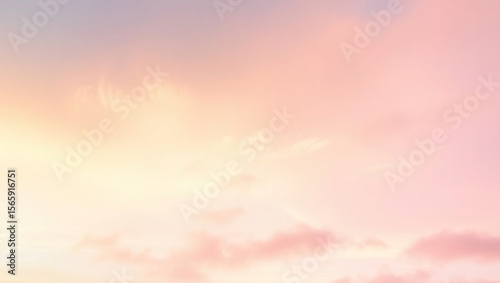 Soft pastel sky with wispy clouds and a gradient of pink and yellow hues.