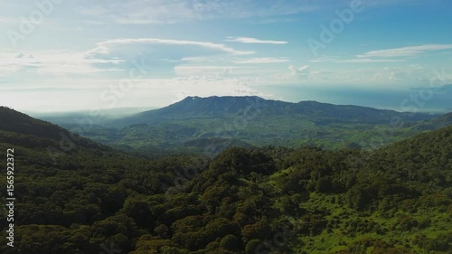 Wallpaper Mural High above Mount Apo’s slopes, the lens pushes forward across dense forest canopies toward a saw-toothed ridge and the shimmering Davao Gulf, all framed by crisp blue sky and cotton clouds. Torontodigital.ca