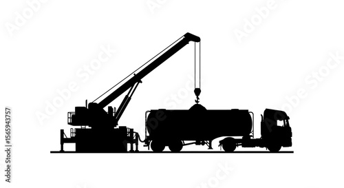 Silhouette of a crane loading a tanker truck, industrial scene.