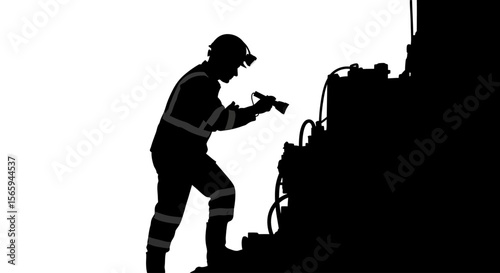 Silhouette of a rescue worker inspecting damaged machinery.