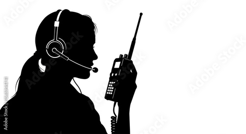 Silhouette of a woman wearing a headset and holding a walkie-talkie, communicating.