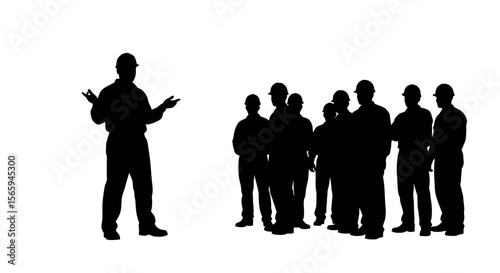 Foreman addressing a group of construction workers during a briefing or safety meeting.