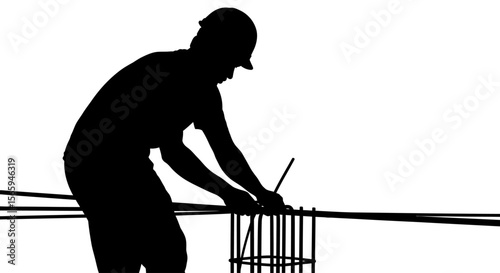 Silhouette of a construction worker tying rebar on a construction site, wearing a hard hat.