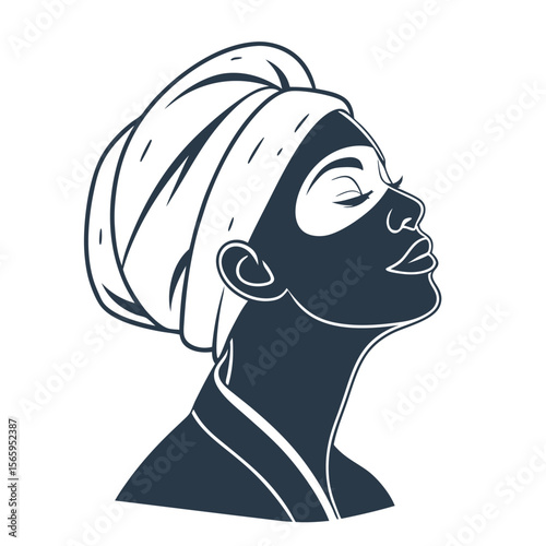 Elegant woman with face mask and towel wrapped around head enjoying a relaxing spa treatment
