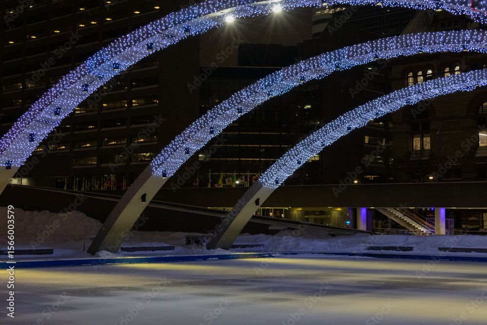 Obraz premium White garlands on the arches above the ice arena.