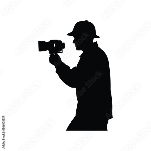 Silhouette of a man with camera and hat taking a picture.