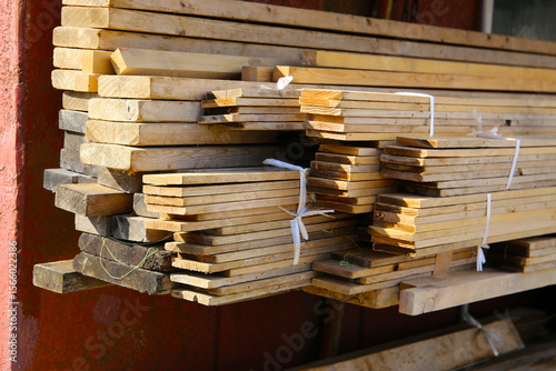 Wallpaper Mural Stack of wooden planks tied with plastic straps, stored outdoors. Torontodigital.ca