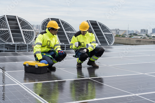 Solar panel, Solar grid tie system on rooftop of building, Solar power system. Team of engineer or technicians maintaining and repairing solar systems, quality control construction of solar farms